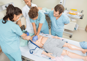 practical cpr training in hospital nurses practicing cpr simulation on medical manikin